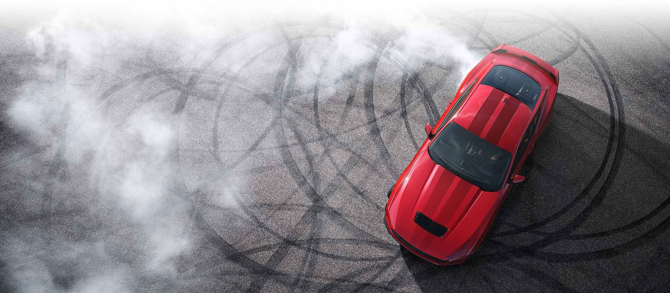 Overhead view of a 2024 Ford Mustang® model with tire tracks on pavement | Freeport Ford in Freeport IL