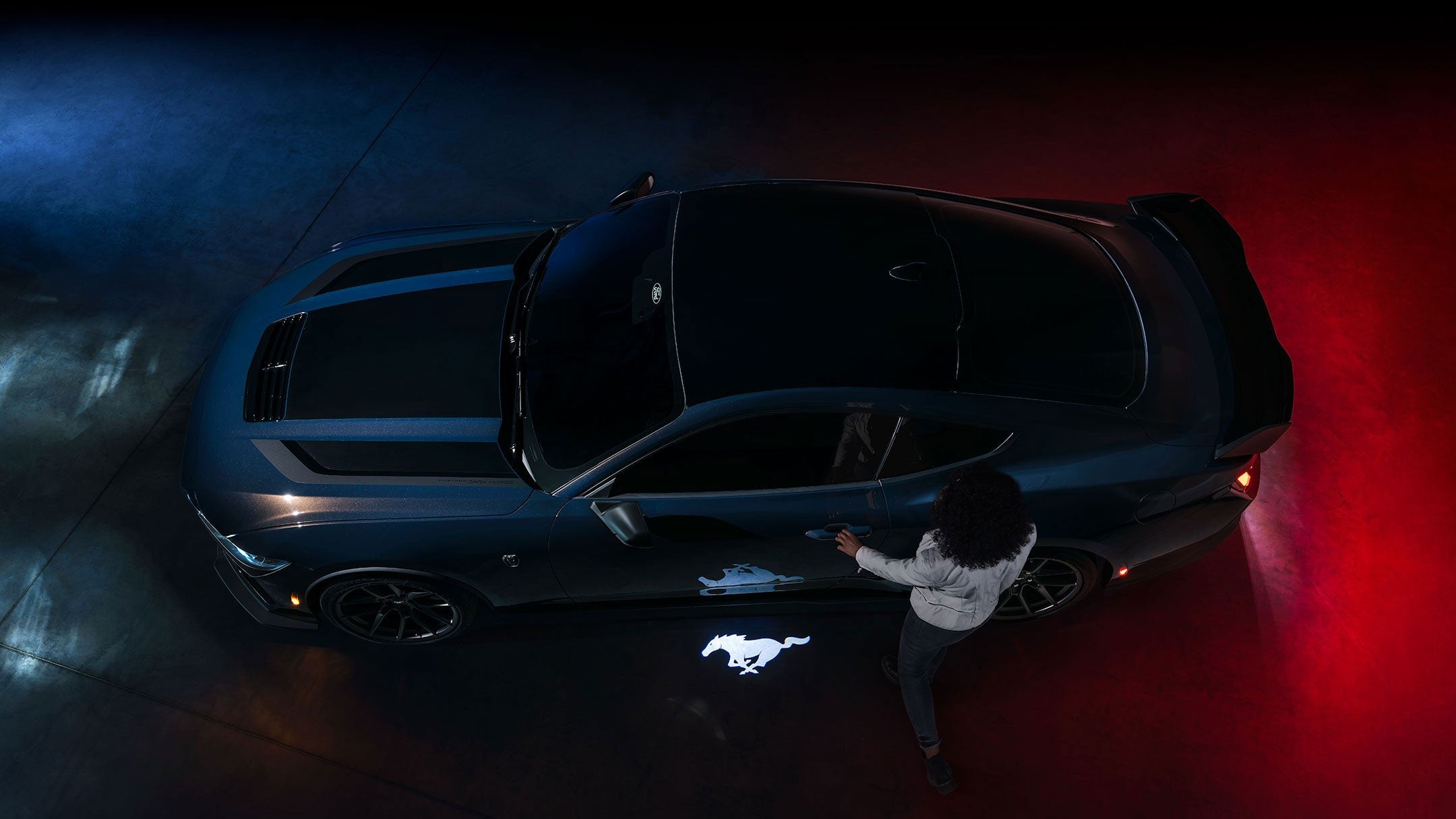 2024 Ford Mustang® Dark Horse™ model with a driver approaching the vehicle | Freeport Ford in Freeport IL