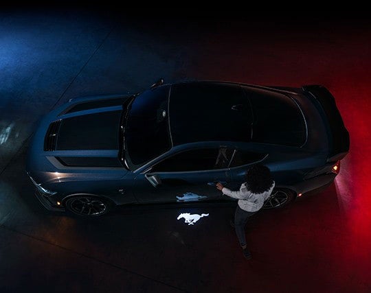 2024 Ford Mustang® Dark Horse™ model with a driver approaching the vehicle | Freeport Ford in Freeport IL