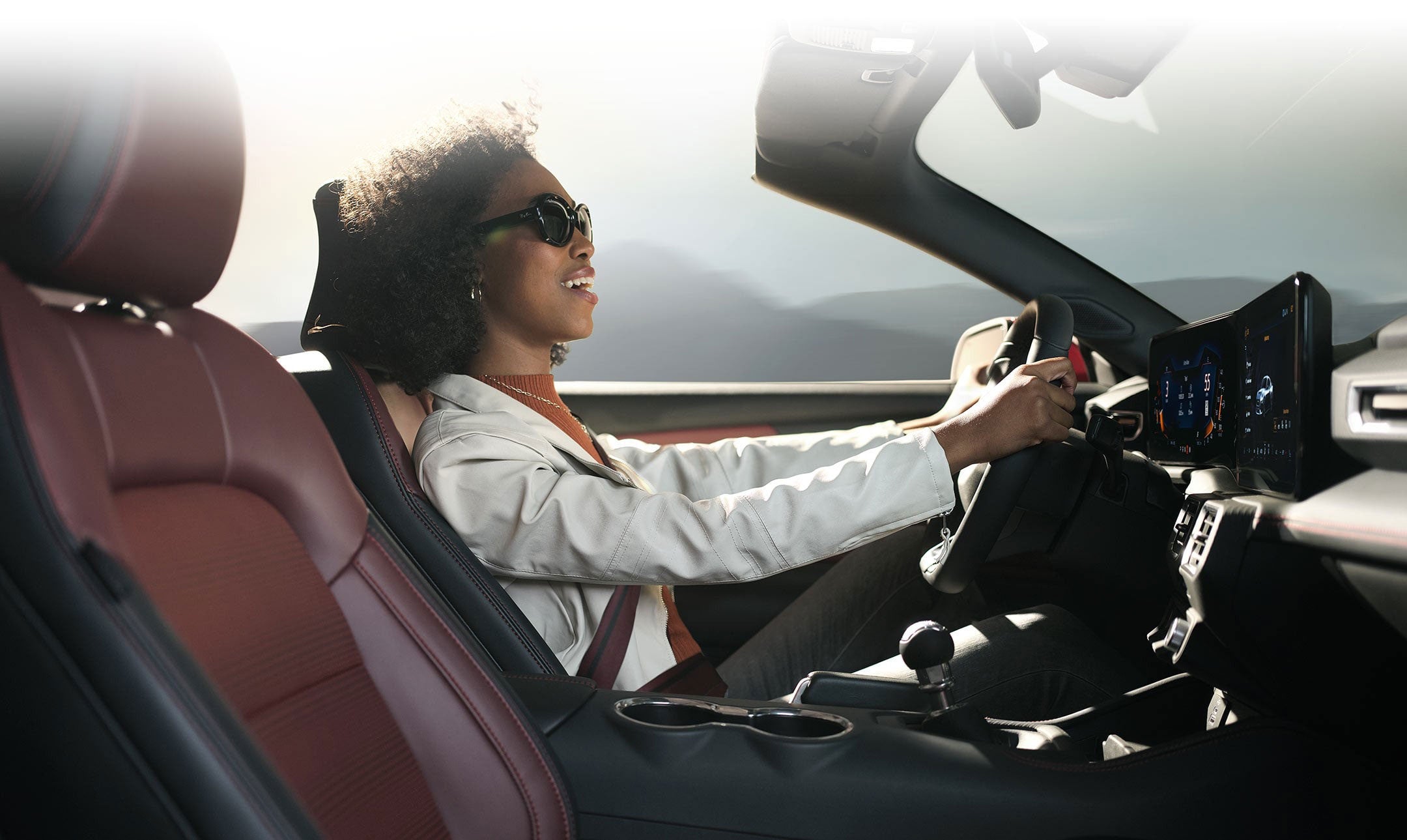 Person sitting in the driver’s seat of a 2024 Ford Mustang® convertible | Freeport Ford in Freeport IL