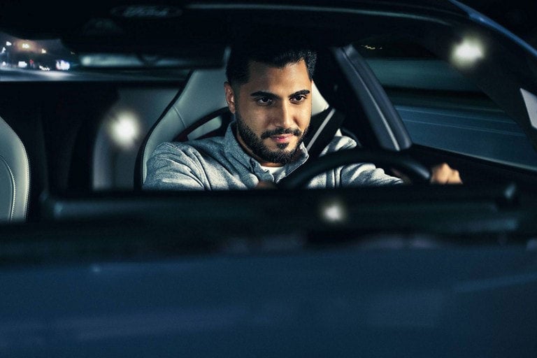 Person sitting in the driver’s seat of a parked 2024 Ford Mustang® coupe | Freeport Ford in Freeport IL